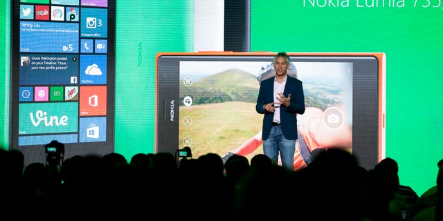 Chris Weber, CVP, Mobile Devices Sales of Microsoft  presents the new Lumia 730 and 735 smart phones during his keynote speech  at a Microsoft Nokia presentation event at the consumer electronic fair IFA in Berlin, Thursday, Sept. 4, 2014. (AP Photo/Markus Schreiber)