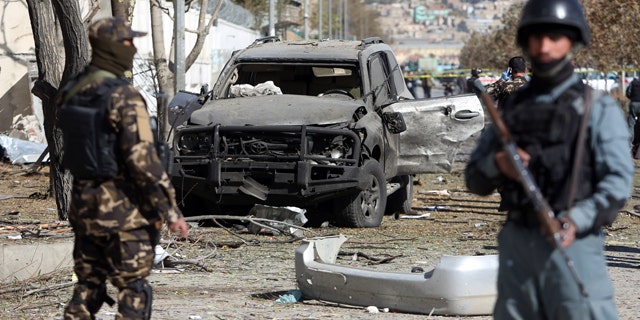 November 16, 2014: Afghan security forces inspect the site of a suicide attack in Kabul. A suicide bomber tried to assassinate a prominent female member of Afghanistan's parliament on Sunday, killing three people and wounding the lawmaker, a senior official said. (AP Photo/Rahmat Gul)