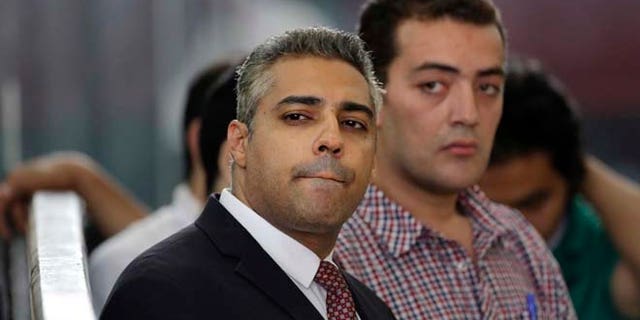June 4, 2015: Canadian Al-Jazeera English journalist Mohammed Fahmy, left, and his Egyptian colleague Baher Mohammed listen in a courtroom in Tora prison in Cairo, Egypt.