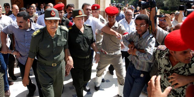 Sept. 16, 2011: Egypt's military ruler field marshal Mohammed Hussein Tantawi, left, and Sami Anan Egyptian chief of staff of the armed forces, are surrounded by military policemen and cameramen, in Cairo, Egypt.