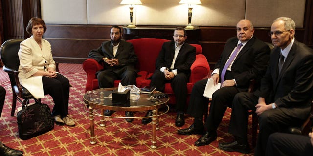 July 29, 2013: European Union foreign policy chief Catherine Ashton, left, meets with Mahmoud Taha, a leader in the Construction and Development Party, the political wing of the former Gamaa Islamiya militant group, second left, Hesham Kandil, former Egyptian Prime Minister, center, Amr Darrag, a member of the Muslim Brotherhood's Freedom and Justice Party, second right, Mohammed Ali Bishr, a member of the Muslim Brotherhood’s leadership council, right, in Cairo. (AP Photo)