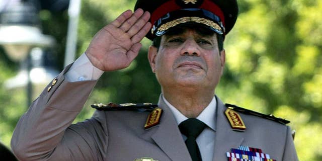 FILE - In this Wednesday, April 24, 2013 file photo, Gen. Abdel-Fattah el-Sissi of Egypt's Defense Minister salutes during an arrival ceremony for U.S. Secretary of Defense Chuck Hagel at the Ministry of Defense in Cairo, Egypt. On Saturday, March, 8, 2014 interim Egyptian President Adly Mansour issued a law regulating the upcoming election, which is expected to be held by the end of April. As he nears announcing a run for Egypt’s presidency, El-Sissi has been focusing on preparing an economic program, senior generals and government officials say, demonstrating the wariness within the military over the scale of problems facing the country. (AP Photo/Jim Watson, Pool, File)