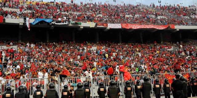 Nov. 4, 2012: In this file photo, Egyptian riot police stand guard at the Borg El-Arab Stadium stadium near Alexandria, Egypt, before Egypt's Al-Ahly club takes on Tunisia's Esperance for a match in the first leg of the African Champions League final near Alexandria, Egypt.