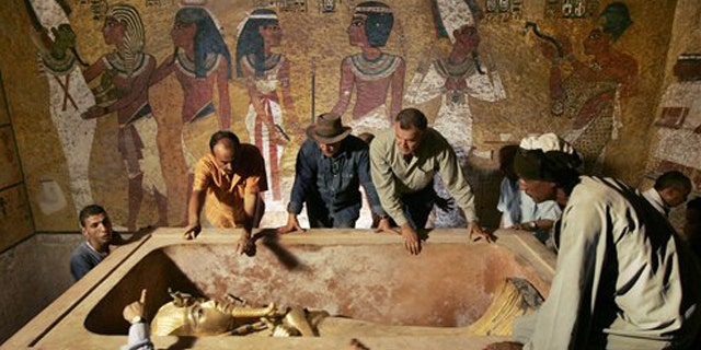 Egypt's antiquities chief Dr. Zahi Hawass (center) supervised the removal of King Tutankhamun from the stone sarcophagus in his underground tomb in the famed Valley of the Kings in Luxor, Egypt. DNA tests were performed on the world's most famous ancient king to address lingering mysteries over his lineage, said the antiquities department.