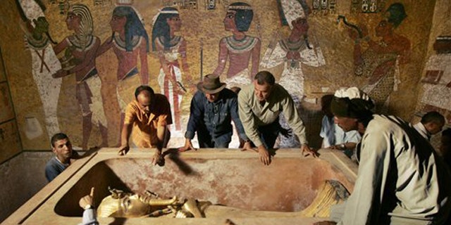 Egypt's antiquities chief Dr. Zahi Hawass (center) supervised the removal of King Tutankhamun from the stone sarcophagus in his underground tomb in the famed Valley of the Kings in Luxor, Egypt. DNA tests were performed on the world's most famous ancient king to address lingering mysteries over his lineage, said the antiquities department.