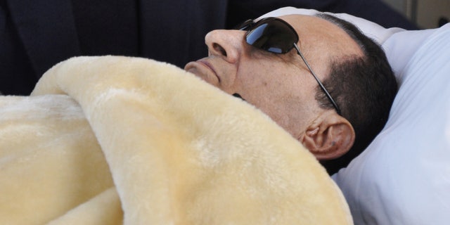 FILE - former Egyptian President Hosni Mubarak is wheeled into court in Cairo, Egypt.