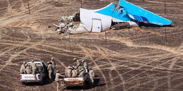 FILE - In this Sunday, Nov. 1, 2015 photo provided by Russian Emergency Situations Ministry, Egyptian Military on cars approach a plane's tail at the wreckage of a passenger jet bound for St. Petersburg in Russia that crashed in Hassana, Egypt. (Maxim Grigoriev/Russian Ministry for Emergency Situations via AP, File)