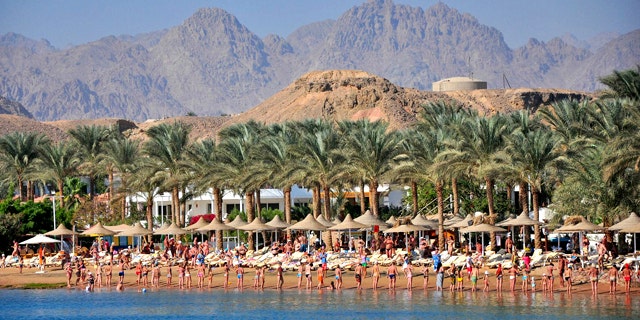 Tourists who were due to participate in an aquatic exercise class perform on the sand instead, at the Egyptian Red Sea resort of Sharm el-Sheikh, Egypt, Monday, Dec. 6, 2010. Egyptian authorities have indefinitely closed the resort's beaches for swimming after oceanic white tip sharks mauled three Russians and a Ukrainian tourist last week, and tore the arm off an elderly German tourist on Sunday, killing her almost immediately.