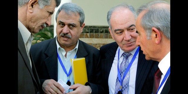 March 24, 2013: Syrian Alawites Mahmoud Maraie, second left, and Bassam al-Malek, second right, talk with other members of the Syrian Alawite sect who are opposed to Syrian President Bashar Assad in Cairo, Egypt. Members of Assad's Alawite sect met in Cairo on Sunday in an attempt to distance themselves from the Damascus regime in its crack down on the Syrian revolution.