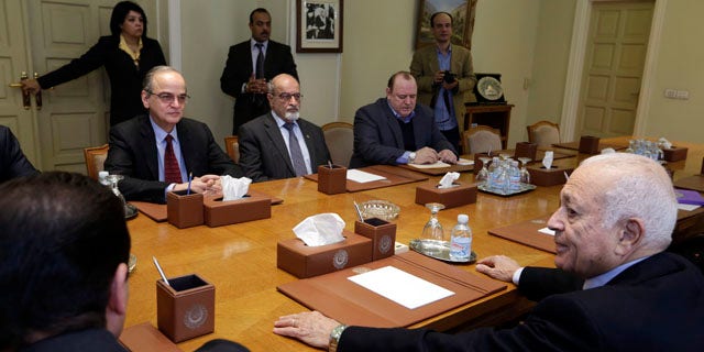 Dec. 27, 2014: The Arab League's Secretary-General Nabil Elaraby, right, meets with Hadi Bahra, the head of the Syrian National Coalition, the country's main political opposition group, left, and Haitham al-Maleh, a member of the group, second left, at the league's headquarters in Cairo. (AP Photo/Amr Nabil)