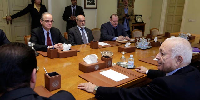 Dec. 27, 2014: The Arab League's Secretary-General Nabil Elaraby, right, meets with Hadi Bahra, the head of the Syrian National Coalition, the country's main political opposition group, left, and Haitham al-Maleh, a member of the group, second left, at the league's headquarters in Cairo. (AP Photo/Amr Nabil)