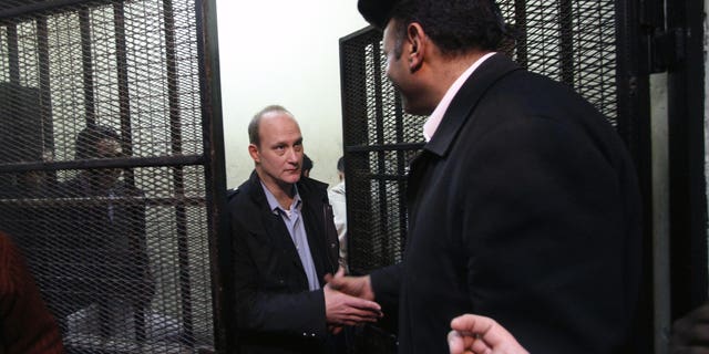 Mar. 8, 2012: American Robert Becker of the National Democratic Institute leaves the defendants' cage after a hearing in the trial of employees of nonprofit groups in Cairo, Egypt.
