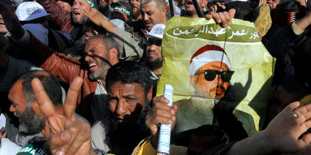Feb. 15, 2013: Supporters of Sheik Omar Abdel-Rahman, a blind Egyptian cleric jailed in the United States for planning a campaign of bombings, call for his release  while one demonstrator holding a poster with his image, during a rally outside Cairo University in Cairo, Egypt.
