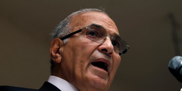 FILE - In this Saturday, May 26, 2012 file photo, Egyptian presidential candidate Ahmed Shafiq speaks to the media during a press conference at his office in Cairo, Egypt. Egyptian officials said Tuesday, Sept. 11, 2012 that Hosni Mubarak's last prime minister, Ahmed Shafiq, has been referred to trial on corruption charges in a case involving the ousted leader's sons. (AP Photo/Khalil Hamra, File)