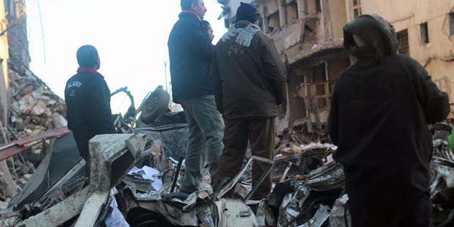 December 24, 2013: Egyptians gather at the scene of an explosion at a police headquarters building that killed at least a dozen people, wounded more than 100, and left scores buried under the rubble, in the Nile Delta city of Mansoura, 70 miles north of Cairo. The country's interim government accused the Muslim Brotherhood of orchestrating the attack, branding it a "terrorist organization."
