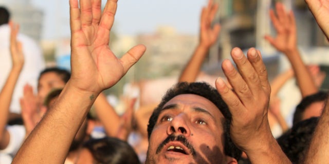 Angry Egyptian Christians protest against the military ruling council in Cairo Egypt, Monday, Oct.10, 2011, a day after at least more than two dozen were killed when Christians, angered by a recent church attack, clashed Sunday night with Muslims and security forces outside the state television building in central Cairo.
