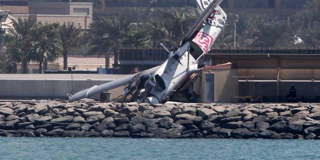 An aircraft belonging to a Dubai skydiving company is seen after crashing off the runway Friday, Oct. 2, 2015, in Dubai, United Arab Emirates. (AP Photo/Kamran Jebreili)