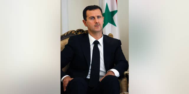 FILE - This Wednesday, Aug. 19, 2009 file photo shows Syrian President Bashar Assad during a meeting with his Iranian counterpart Mahmoud Ahmadinejad at the presidency in Tehran, Iran. In excerpts of an interview with Czech publication Literarni Noviny, published by Syria's state media Wednesday, Jan. 14, 2015, Assad says Syria is against the killing of civilians anywhere in the world and sympathizes with the families of victims of last week's terrorist attack in France. Assad also called on Western politicians to reconsider their backing of Syrian rebels and opposition. (AP Photo/Vahid Salemi, File)