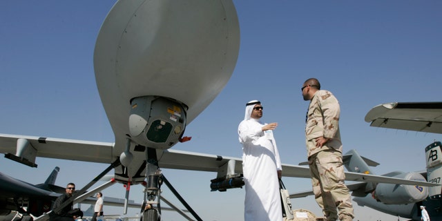 Nov. 12, 2007 - FILE photo of an Emarati visitor asks a U.S. military representative questions, as they stand next to an MQ-1 Predator spy plane, during the 2nd day of the 10th Dubai Airshow, at the Dubai airport, United Arab Emirates.