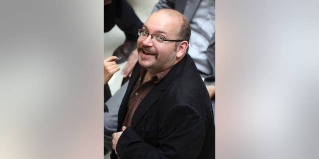 FILE - In this photo April 11, 2013 file photo, Jason Rezaian, an Iranian-American correspondent for the Washington Post, smiles as he attends a presidential campaign of President Hassan Rouhani in Tehran, Iran. The brother of the detained Washington Post correspondent said Wednesday, Feb. 18, 2015 that a new lawyer chosen by the family has been unable to meet with the Iranian-American journalist to complete formalities that would allow him to represent him.(AP Photo/Vahid Salemi, File)