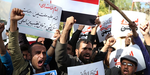 April 13, 2015: Yemeni expatriates and Iranians chant slogans during a protest against the Saudi-led coalition strikes on Yemen, in front of the Saudi Embassy in Tehran. (AP Photo/Ebrahim Noroozi)