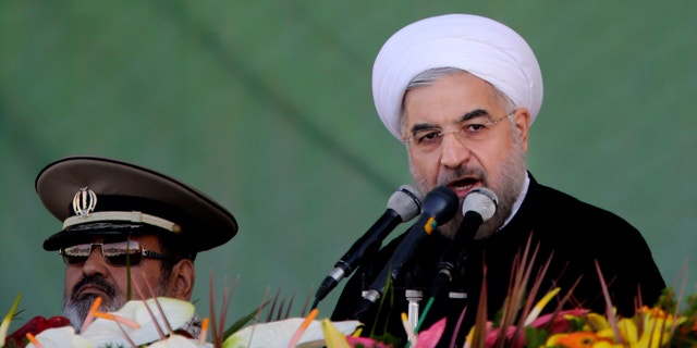 Sept, 22, 2013 - Iran's President Hassan Rouhani, gives a speech during an annual military parade in Tehran, Iran, on the eve of landmark trip to gather alongside Western leaders. Rouhani offered his most expansive vision that a deal to settle the impasse over Tehran's nuclear program could open doors for greater cooperation on regional flash points such as the Syrian civil war.