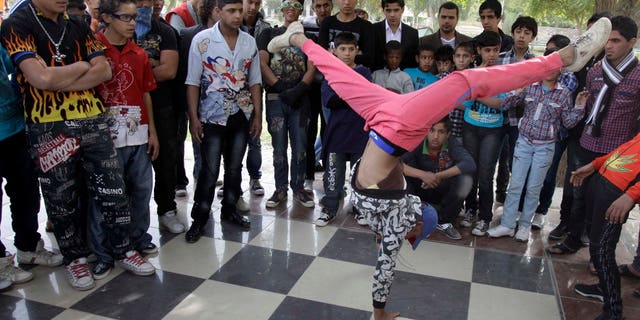 Nov. 10, 2011: An Iraqi boy dances to hip hop music in Baghdad, Iraq. After more than eight years in Iraq, the departing American military's legacy includes a fledgling democracy, bitter memories of war, and for the nation's youth, rap music, tattoos and slang.