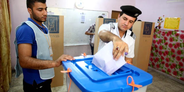 April 28, 2014 - An Iraqi traffic policeman casts his vote at a polling center in Baghdad, Iraq. Iraqi officials say suicide bombers have targeted polling centers as soldiers and security forces cast ballots ahead of parliamentary elections.