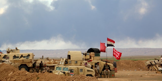 March 4, 2015: Smoke rises as the Iraqi army, supported by volunteers, battles Islamic State extremists outside Tikrit, 80 miles north of Baghdad. (AP Photo)