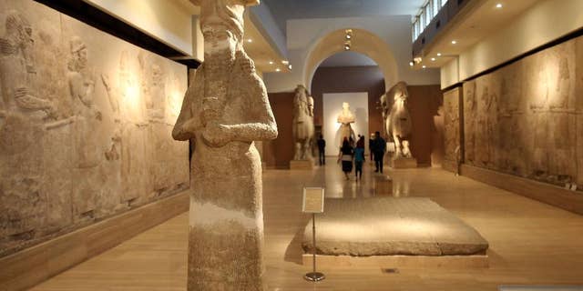 March 15, 2015: People observe ancient artifacts at the Iraqi National Museum after its reopening in the wake of the recent destruction of Assyrian archaeological sites by the Islamic State group in Mosul, as they visit the museum in Baghdad.