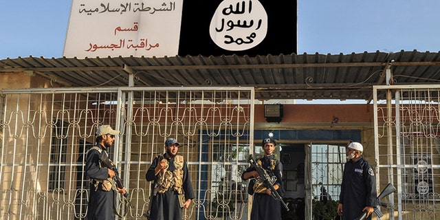 ISIS operatives standing guard during the terrorist group's peak in 2014.
