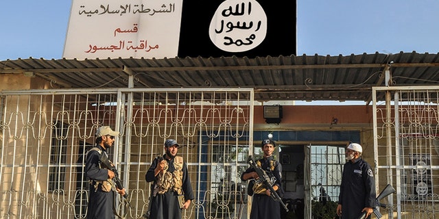 ISIS operatives standing guard during the terrorist group's peak in 2014.