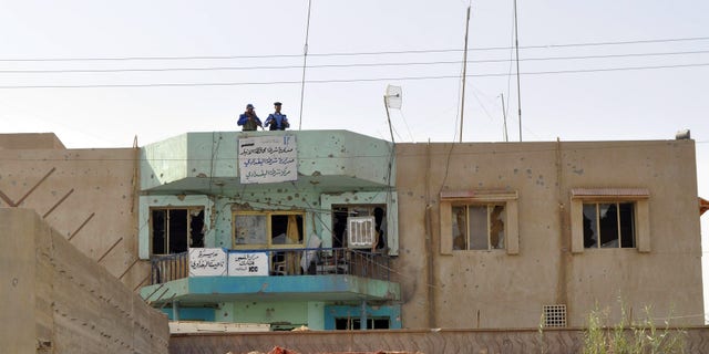 October 3: Iraqi police inspect the damaged at their police station in al-Baghdadi west of Ramadi, 70 miles (115 kilometers) west of Baghdad, Iraq.