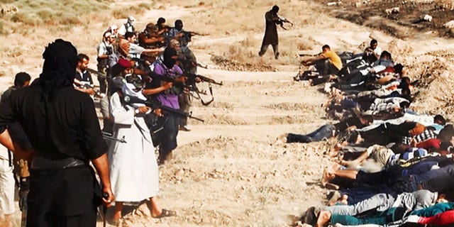 This image posted on a militant website on Saturday, June 14, 2014, which has been verified and is consistent with other AP reporting, appears to show militants from the al-Qaida-inspired Islamic State of Iraq and the Levant (ISIL) taking aim at captured Iraqi soldiers wearing plain clothes after taking over a base in Tikrit, Iraq. The Islamic militant group that seized much of northern Iraq has posted photos that appear to show its fighters shooting dead dozens of captured Iraqi soldiers in a province north of the capital Baghdad. Iraq's top military spokesman Lt. Gen. Qassim al-Moussawi confirmed the photos authenticity on Sunday and said he was aware of cases of mass murder of Iraqi soldiers. (AP Photo via militant website)