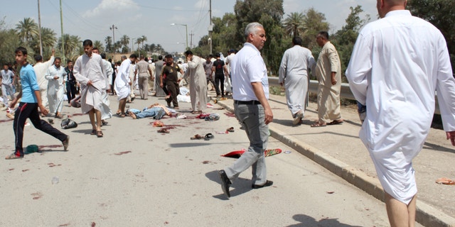May 17, 2013 - Iraqis gather at the scene of a bomb attack in Baqouba, northeast of Baghdad, Iraq.