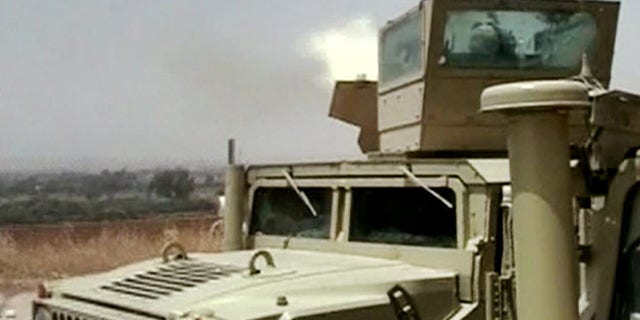 Monday, June 9, 2014 image taken from video obtained from the Iraqi Military, which has been authenticated based on its contents and other AP reporting, an Iraqi army tank fires towards militants during clashes in in the northern city of Mosul, Iraq. Insurgents on Tuesday pressed their efforts to seize effective control of Iraqs second-largest city of Mosul on Tuesday after Iraqi security forces abandoned their posts and militants overran the provincial government headquarters and other key buildings, dealing a serious blow to Baghdads attempts to tame a widening insurgency in the country.