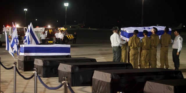 July 20, 2012: Israeli soldiers carry the coffins of people killed in a bombing in Bulgaria as the remains arrived back at an airport in Tel Aviv, Israel.