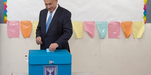March 17, 2015: Israeli Prime Minister Benjamin Netanyahu casts his vote during Israel's parliamentary elections in Jerusalem. (AP Photo/Sebastian Scheiner, Pool)