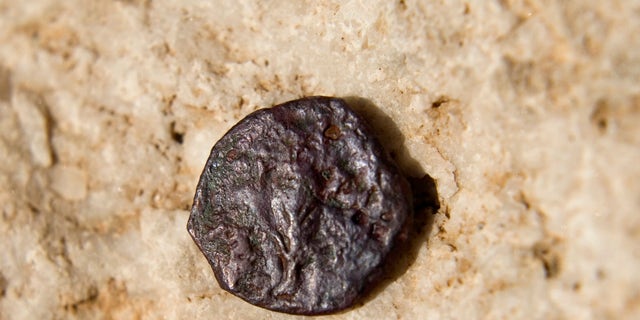 Nov. 23, 2011: An ancient coin, one of 17 discovered in an underground part of the Western Wall, the holiest site where Jews can pray, is seen in a presentation of archeological excavations in Jerusalem's Old City.