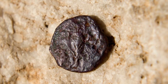 Nov. 23, 2011: An ancient coin, one of 17 discovered in an underground part of the Western Wall, the holiest site where Jews can pray, is seen in a presentation of archeological excavations in Jerusalem's Old City.