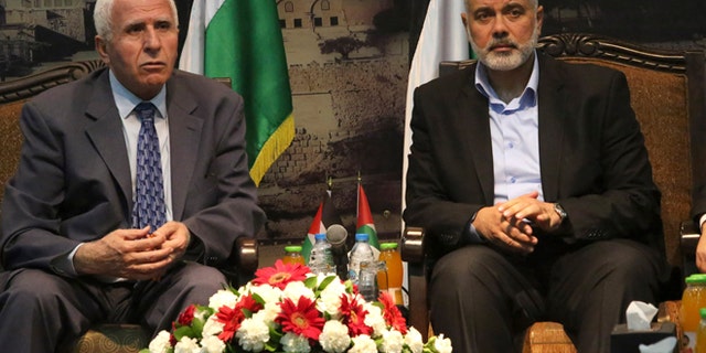 April 22, 2014: Gaza's Hamas Prime Minister Ismail Haniyeh, right, and senior Fatah official Azzam al-Ahmad meet in Gaza for talks aimed at reaching a reconciliation agreement between the two rival Palestinian groups, Hamas and Fatah.
