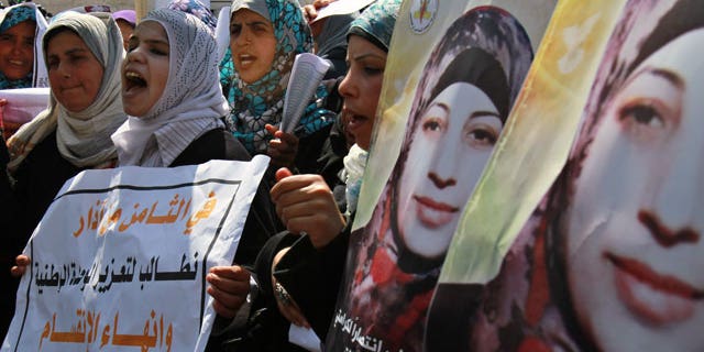 Mar. 8, 2012: Palestinian women take part in a protest in solidarity with Hana Shalabi, a Palestinian prisoner jailed in Israel and who has been on hunger strike for 22 days, and marking International Women's Day in front of the International Red cross offices in Gaza City.