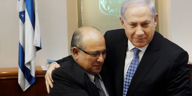 In this Jan. 2, 2011 file photo, Israel's Prime Minister Benjamin Netanyahu, right, hugs Meir Dagan, then outgoing Mossad chief, after thanking him at the beginning of the weekly cabinet meeting in Jerusalem. Israeli media on Thursday, 2 June, 2011, cite the recently retired Mossad chief Meir Dagan as saying there are no plans to attack Iran within the next two years. (AP/File)