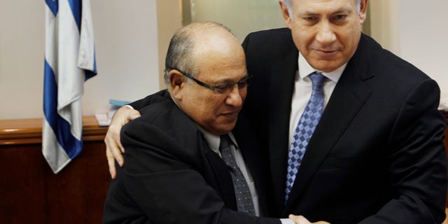 In this Jan. 2, 2011 file photo, Israel's Prime Minister Benjamin Netanyahu, right, hugs Meir Dagan, then outgoing Mossad chief, after thanking him at the beginning of the weekly cabinet meeting in Jerusalem. Israeli media on Thursday, 2 June, 2011, cite the recently retired Mossad chief Meir Dagan as saying there are no plans to attack Iran within the next two years. (AP/File)