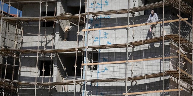 Nov. 9: A construction worker looks on at a site in the West Bank Jewish settlement of Ariel. The official Palestinian news agency said the Palestinian president wants a U.N. Security Council session to discuss such Israeli settlement construction.