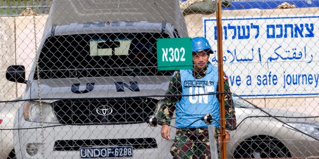 March 7, 2013 - A U.N. peacekeeper from the Philippines crosses back from Syria at the Quneitra Crossing between Syria and the Israeli-controlled Golan Heights.