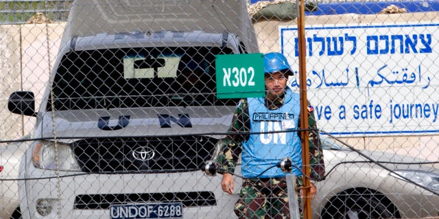 March 7, 2013 - A U.N. peacekeeper from the Philippines crosses back from Syria at the Quneitra Crossing between Syria and the Israeli-controlled Golan Heights.