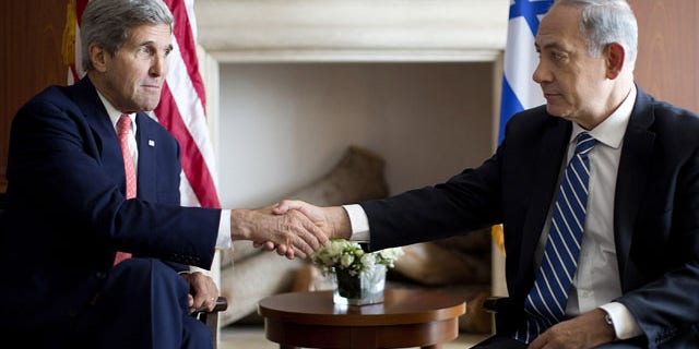 November 6, 2013: U.S. Secretary of State John Kerry, right, shakes hands with Israeli Prime Minister Benjamin Netanyahu in Jerusalem, Wednesday, Nov. 6, 2013. (AP Photo/Jason Reed, Pool)