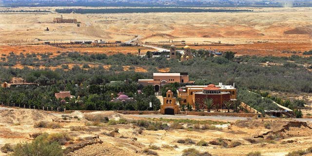 This July 6, 2015 photo shows the baptismal area on the eastern bank of the Jordan River in South Shuna, Jordan, foreground, and the baptismal area of the Israeli-run site known as Qasr al-Yahud, with the golden dome church, background, located in a part of the West Bank. UNESCO recently designated Jordan's baptismal area a World Heritage site, over the Israeli-run site of Qasr al-Yahud in the West Bank, which is one of three territories captured by Israel in the 1967 Mideast war. (AP Photo/Raad Adayleh)