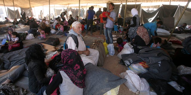 Newly-arrived Syrian refugees gather at Zaatari refugee camp, in Mafraq, Jordan, Wednesday, Aug. 29, 2012. Jordan's has warned Syrian refugees in its tent camp near the Syrian border against rioting. Public security officials say rioting by 200 refugees late Tuesday over the camp's 'poor services' injured 26 Jordanian security officers. (AP Photo/Mohammad Hannon)